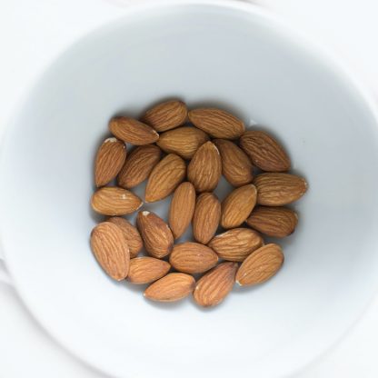 brown almond nuts on white ceramic bowl