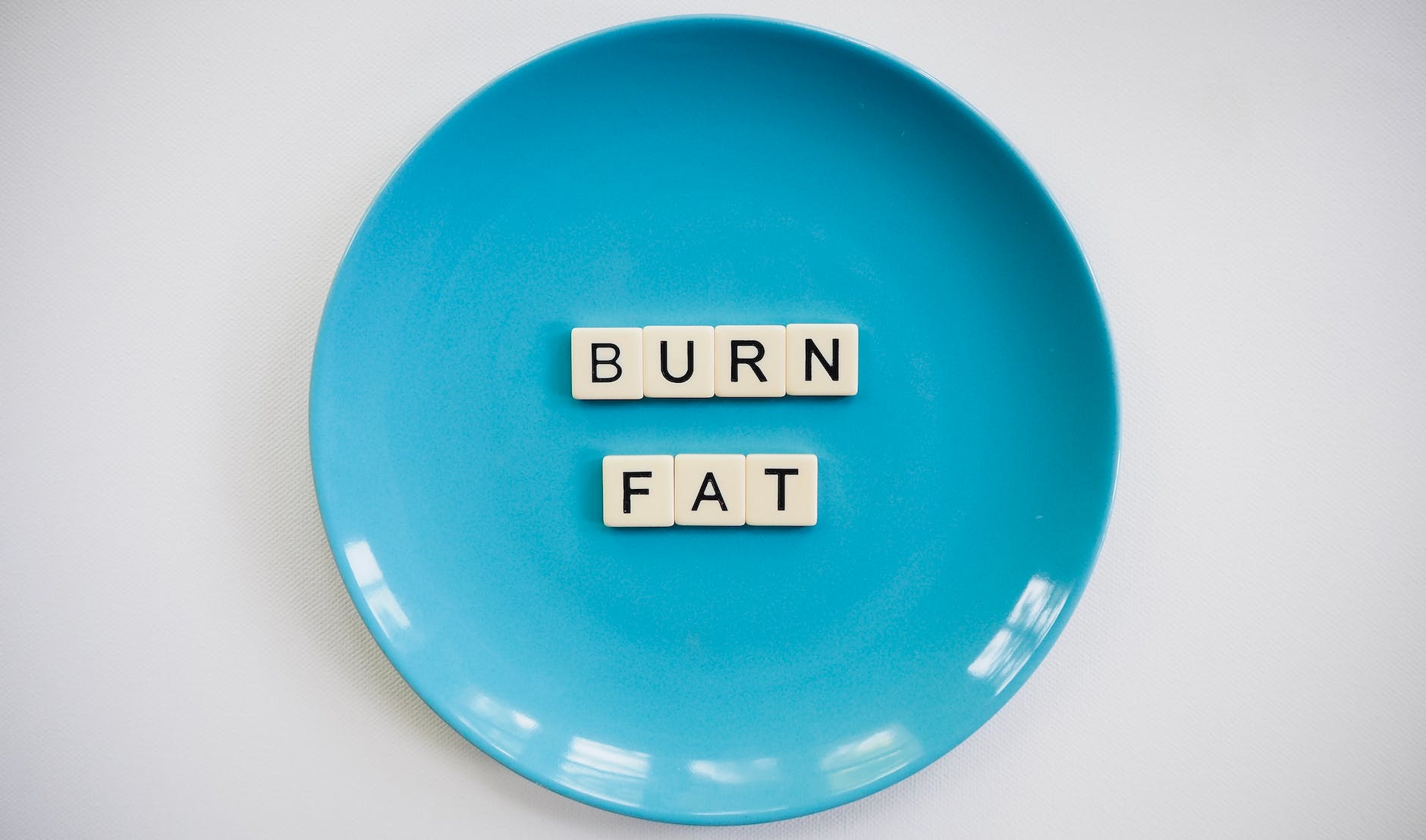 photo of a burn fat text on round blue plate