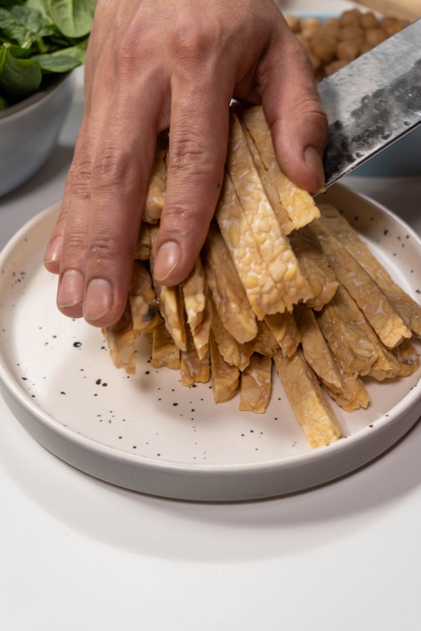 a person holding tempeh slices