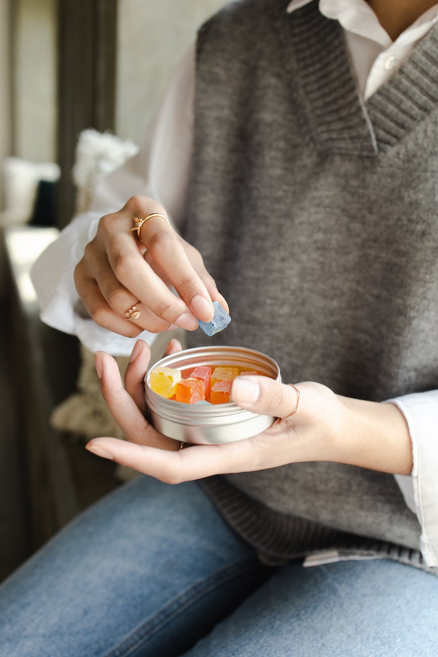 a person holding a can of gummy candy