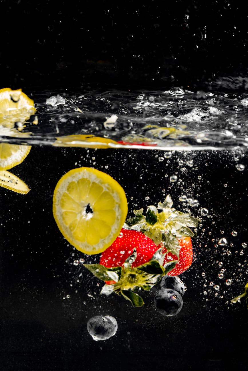 sliced lemon and strawberries in water