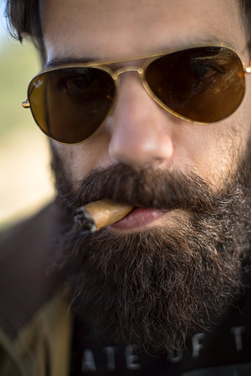 close up photo of man smoking cigar