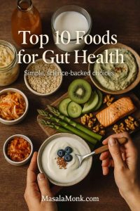Top-down photo of foods for gut health—yogurt with blueberries and flax, kimchi, sauerkraut, kefir, asparagus, salmon, kiwi, walnuts—on a rustic table.