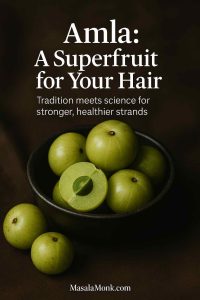 Fresh amla fruits in a dark bowl with text overlay reading ‘Amla: A Superfruit for Your Hair’ and MasalaMonk.com footer.