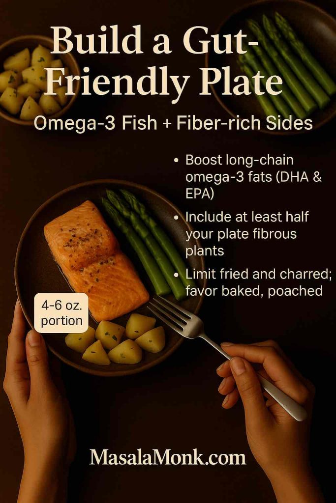 Baked salmon with asparagus and cooled potatoes on a dark plate—omega-3 fish paired with fiber sides to support SCFA-producing bacteria.