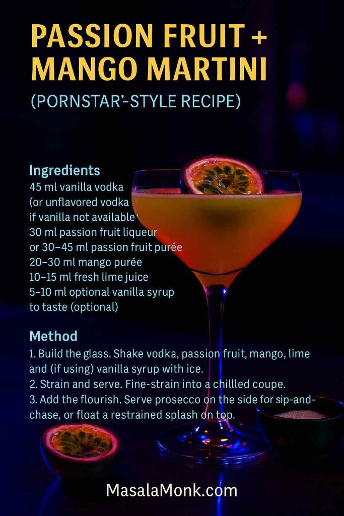 Passion Fruit + Mango Martini recipe card in a moody bar setting: coupe with halved passion fruit garnish, vanilla sugar ramekin and prosecco side; readable ingredients and method overlay; MasalaMonk.com footer.