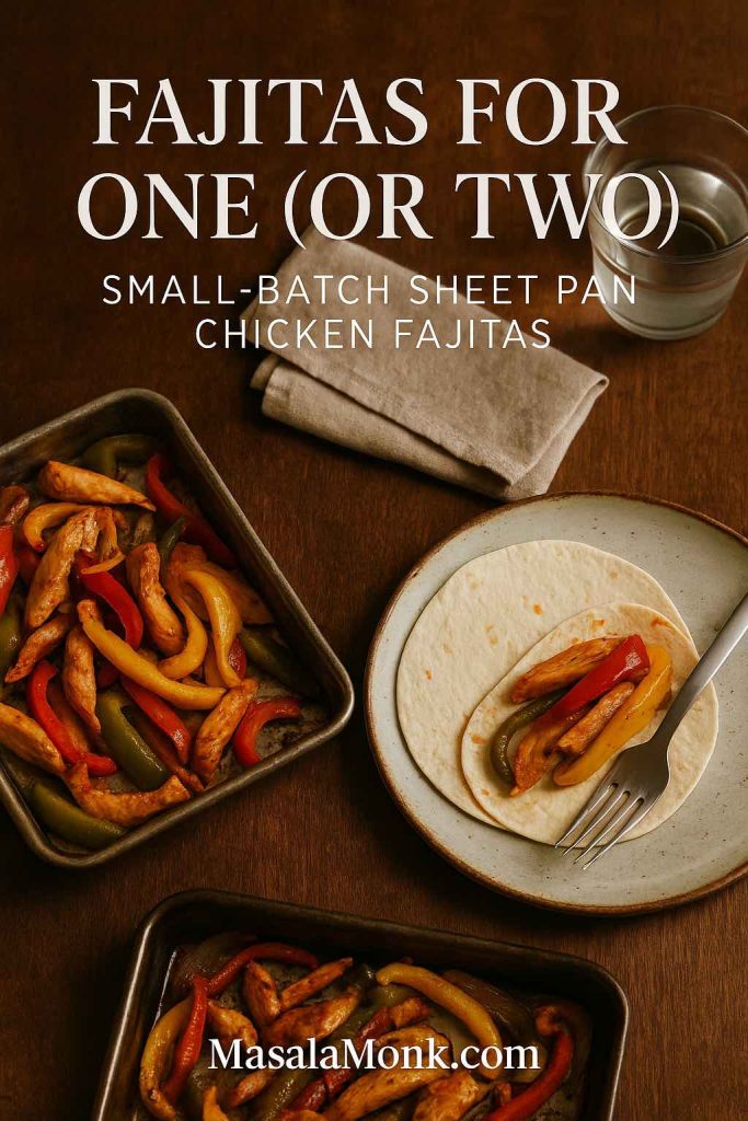 Small sheet pan of chicken fajitas beside a single plate with a tortilla being filled, napkin and glass of water on a wooden table for a fajitas for one or two serving.