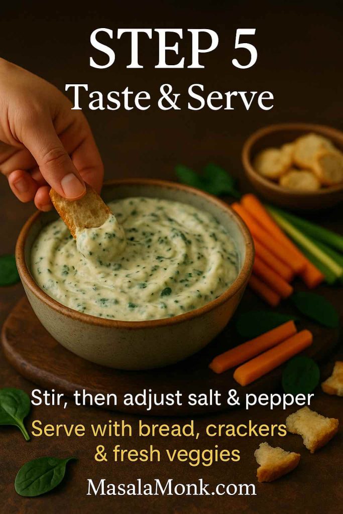Step 5 of classic spinach dip recipe showing a hand dipping toasted bread into a bowl of creamy spinach dip, surrounded by carrot sticks, celery sticks, spinach leaves and bread cubes.