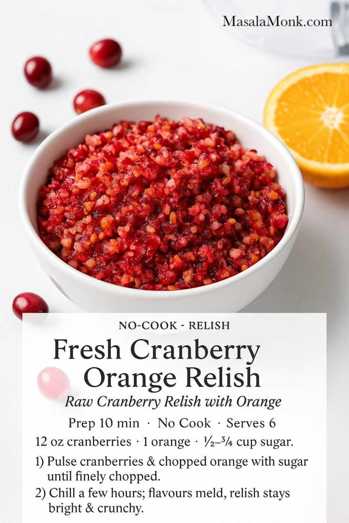 Fresh cranberry orange relish in a white bowl on a bright white surface, with chopped cranberries and orange peel visible, surrounded by fresh cranberries and half an orange, plus a text overlay mini recipe card for raw cranberry relish with orange from MasalaMonk.com.