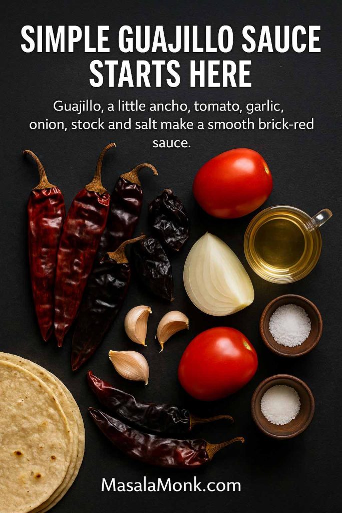 Overhead photo of ingredients for guajillo sauce including dried guajillo and ancho chilies, tomatoes, onion, garlic, stock, oil and bowls of salt on a dark background.