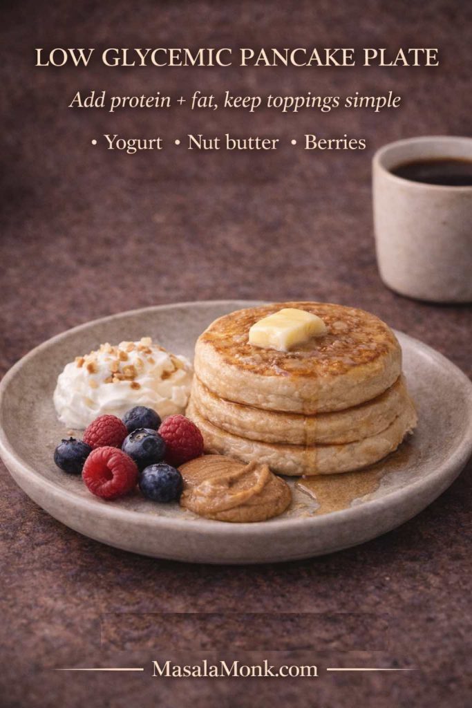 Low glycemic pancake plate with keto pancakes topped with butter, served with Greek yogurt, nut butter, and berries, showing a balanced low carb pancake topping guide.
