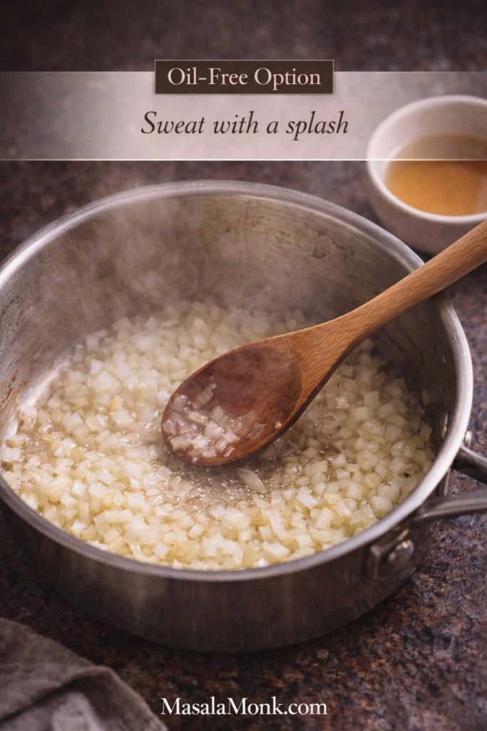 Chopped onions sweating in a saucepan with a splash of broth or water instead of oil, showing how to start an oil free marinara sauce.