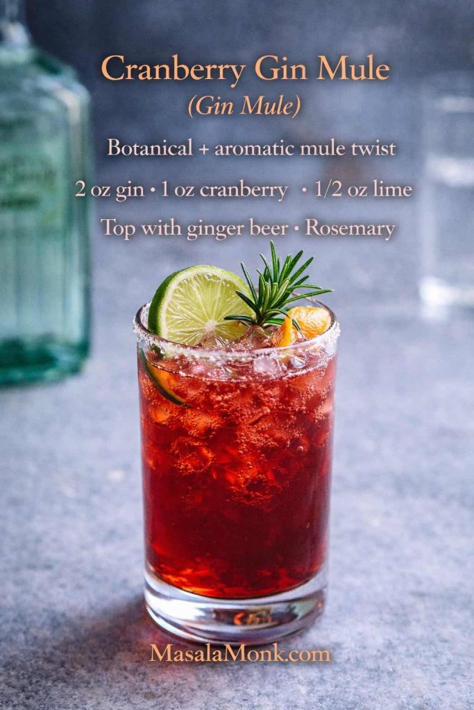 Cranberry gin mule in a tall glass with lime and rosemary, featuring an on-image recipe for a gin mule made with cranberry juice, lime, and ginger beer.