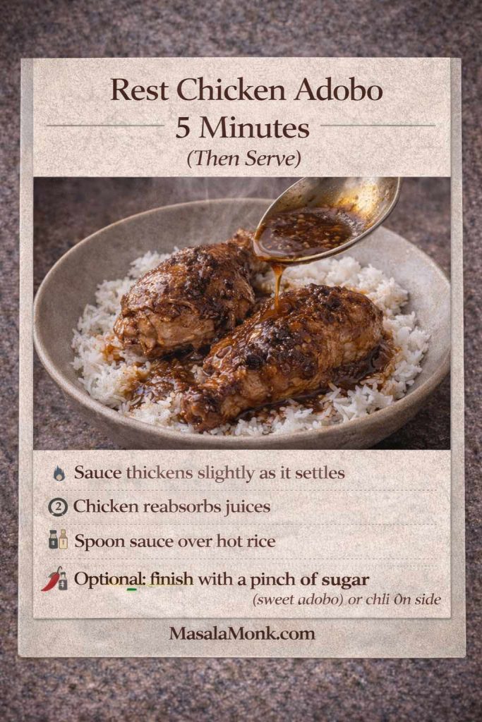 Instructional card titled “Rest Chicken Adobo 5 Minutes (Then Serve).” Photo shows two pieces of chicken adobo on a bowl of white rice while a spoon pours glossy adobo sauce over the chicken. Text notes: sauce thickens slightly as it settles, chicken reabsorbs juices, spoon sauce over hot rice, and an optional finish with a pinch of sugar for sweet adobo or chili on the side. MasalaMonk.com appears in the footer.