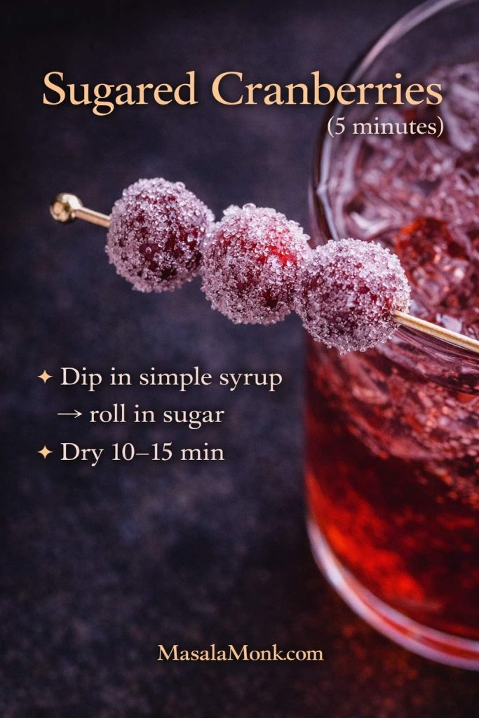 Sugared cranberries on a cocktail pick with a cranberry mule drink in the background, featuring on-image instructions to dip in simple syrup, roll in sugar, and dry 10–15 minutes.