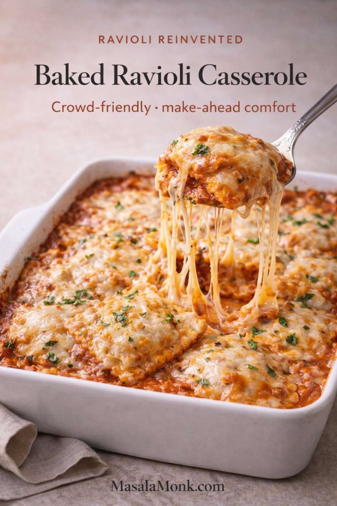 Baked ravioli casserole in a white dish with melted cheese and tomato sauce, showing a spoon lifting a portion with a long cheese pull; text overlay reads “Baked Ravioli Casserole” and “Crowd-friendly • make-ahead comfort,” with MasalaMonk.com in the footer.