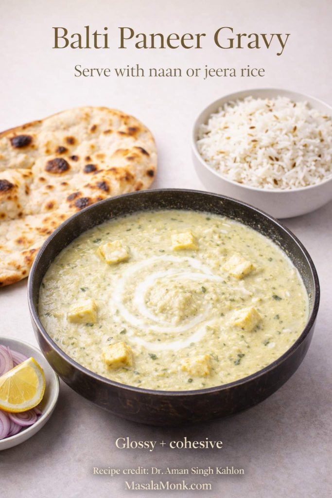 Balti Paneer Gravy served in a bowl with a cream swirl, alongside naan and jeera rice, with lemon and onion salad for a complete restaurant-style vegetarian meal.