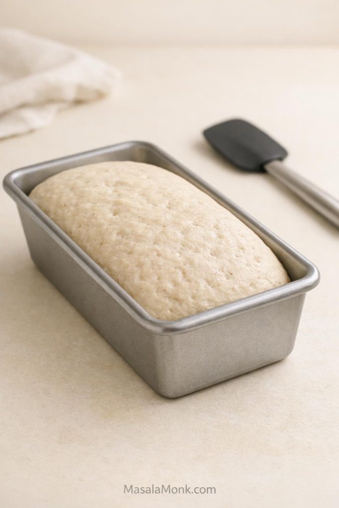 Proofed gluten free sourdough loaf in a loaf pan ready to bake.