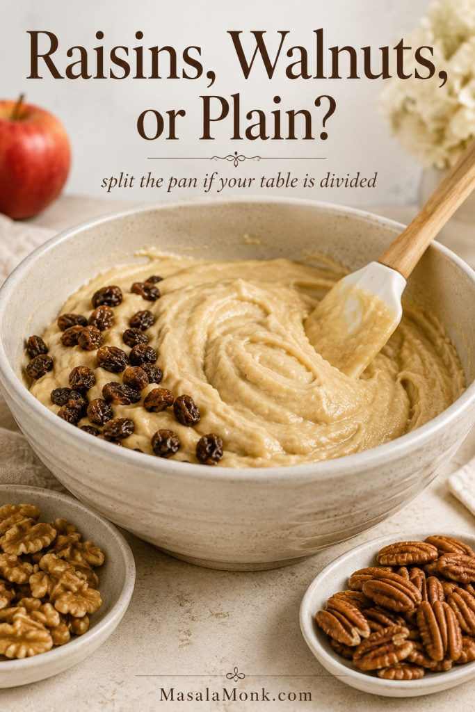Applesauce cake batter with raisins partly folded in and walnuts and pecans shown nearby as add-in options.