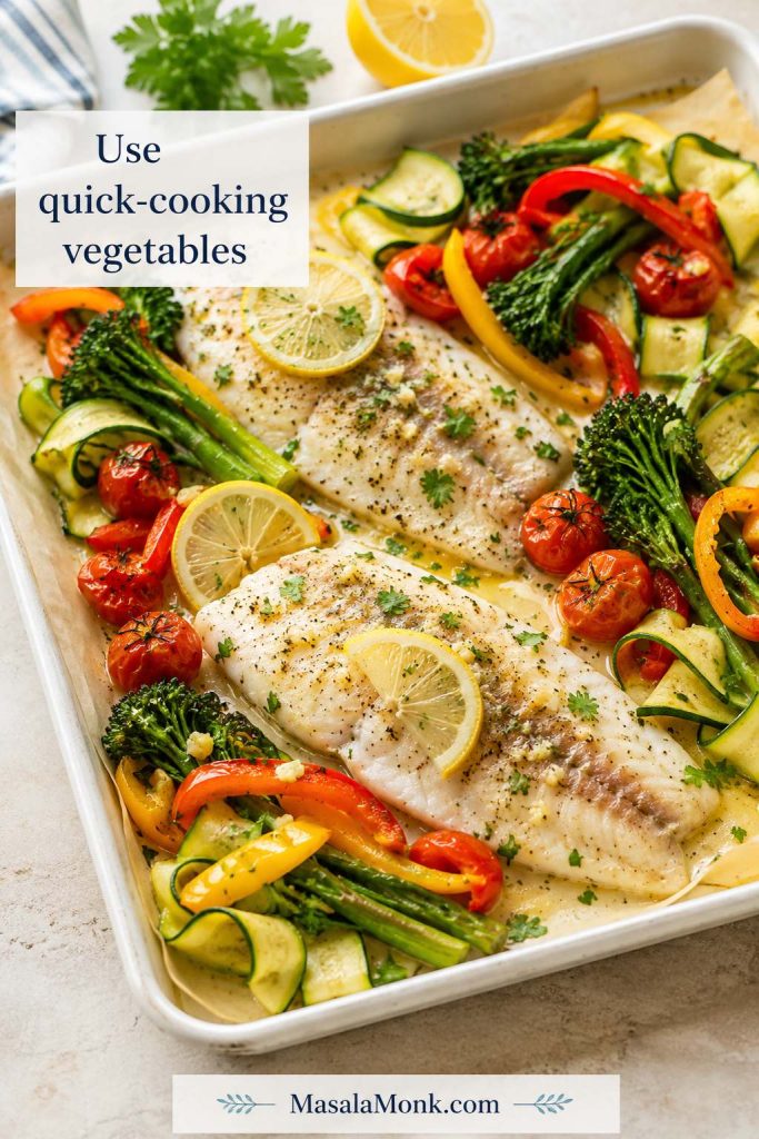 Baked tilapia with quick-cooking vegetables including cherry tomatoes, zucchini, broccolini, bell peppers, lemon, and parsley.