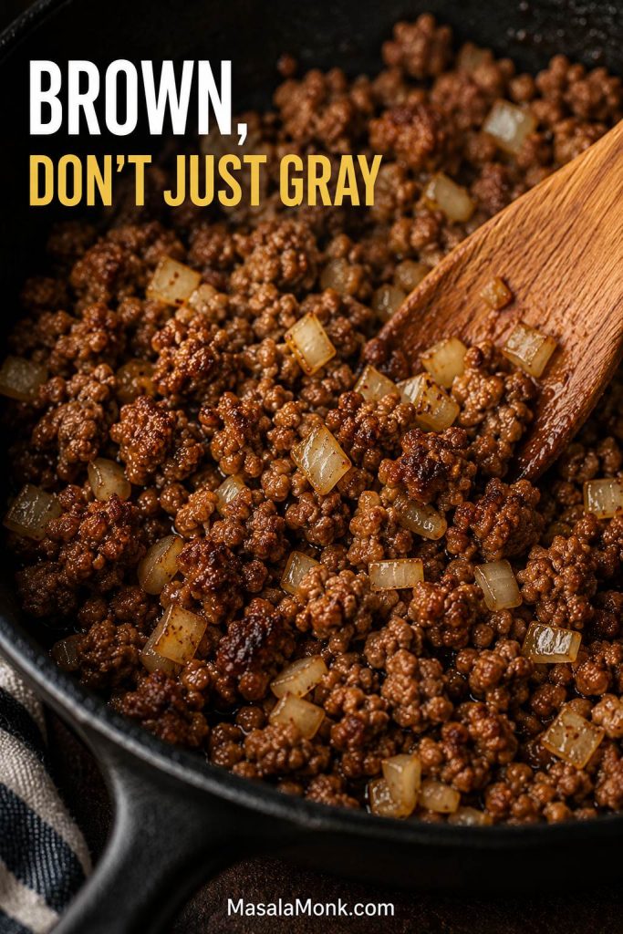 Ground beef browning with onions in a skillet for homemade Hamburger Helper, with browned bits visible on the pan.