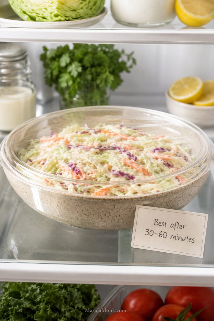 Bowl of creamy coleslaw chilling before serving with a note about resting for 30 to 60 minutes.