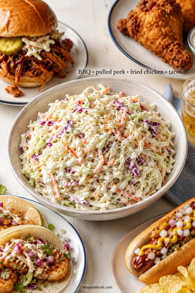 Bowl of creamy coleslaw served with pulled pork, fried chicken, tacos, and a hot dog.