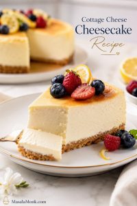 Finished cottage cheese cheesecake slice with creamy filling, crumb crust, berries, and lemon on a dessert plate