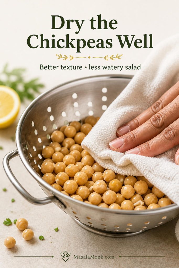 Close-up of rinsed chickpeas being patted dry with a clean towel before making chickpea salad.