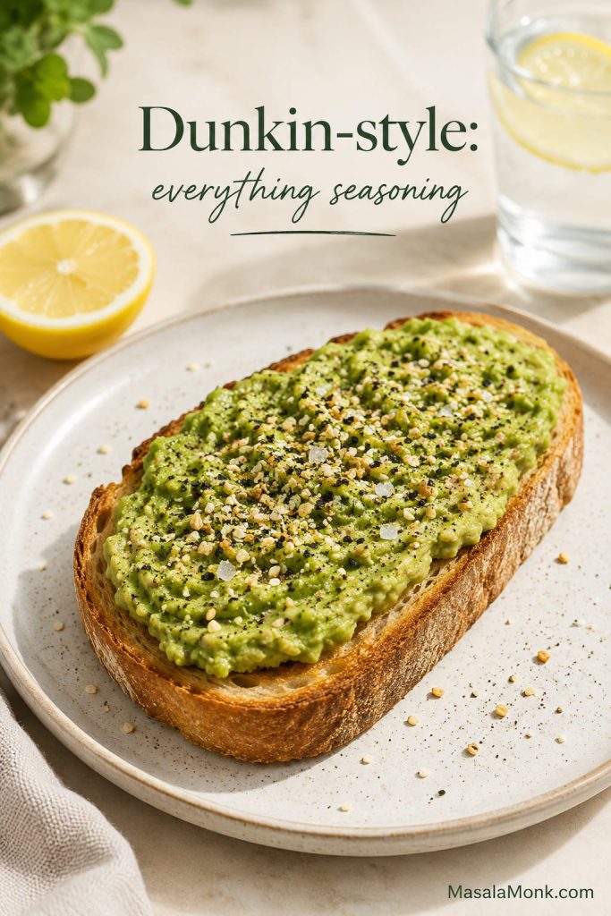 Dunkin-style avocado toast with smooth avocado spread on sourdough, everything seasoning, lemon, and black pepper.