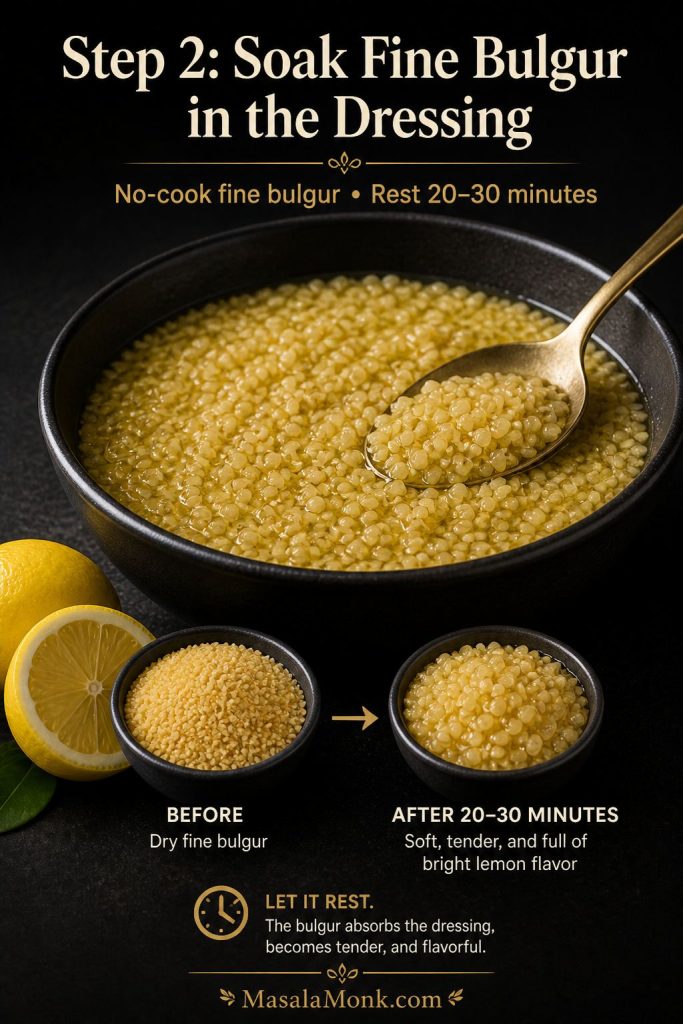 Fine bulgur soaking in lemon and olive oil dressing in a dark bowl, with lemon and olive oil nearby.