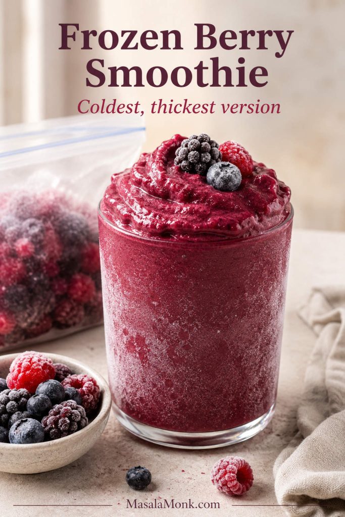 Frozen berry smoothie with frosty glass, frozen mixed berries, and a thick cold texture.