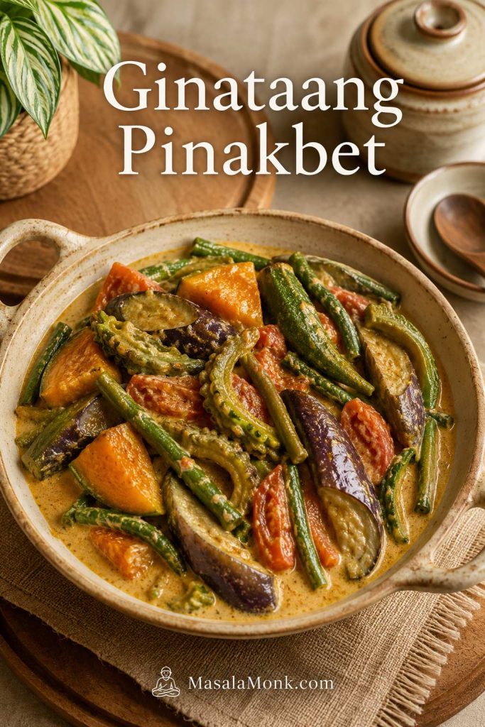 Ginataang pinakbet with creamy coconut milk sauce, squash, long beans, eggplant, okra, and ampalaya in a shallow serving pan.
