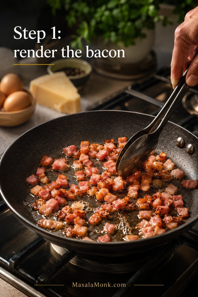 Diced bacon rendering in a skillet with tongs while fat collects in the pan.