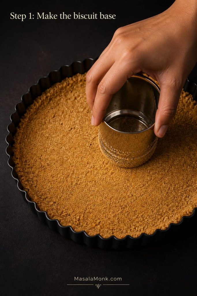 Biscuit crumb base being pressed into a tart tin with a small metal cup for Step 1 of Banoffee Pie.