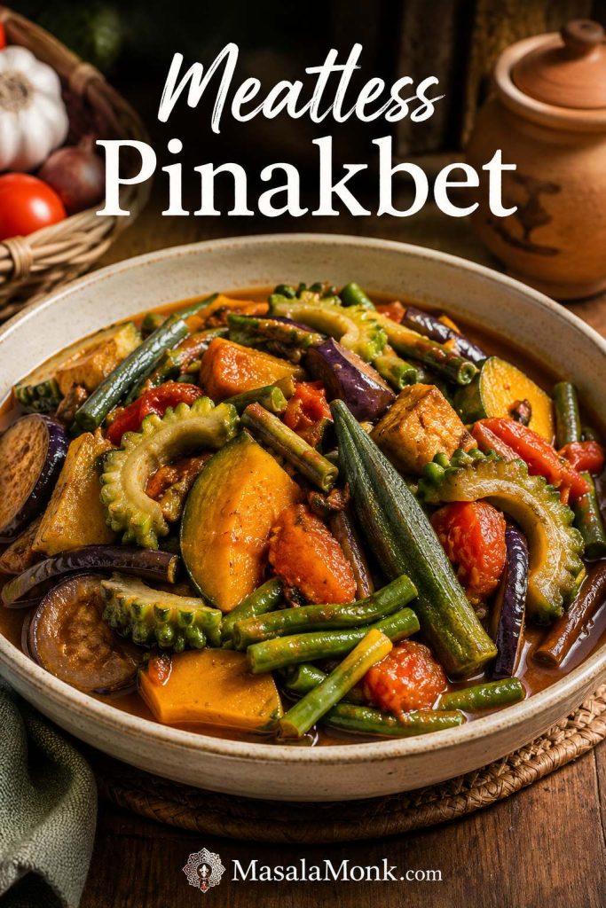 Meatless pinakbet with squash, long beans, okra, eggplant, ampalaya, tomatoes, and glossy savory sauce in a bowl.