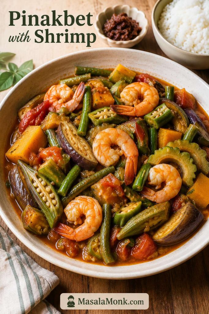 Pinakbet with shrimp, squash, long beans, okra, eggplant, ampalaya, tomatoes, and glossy sauce served with rice.