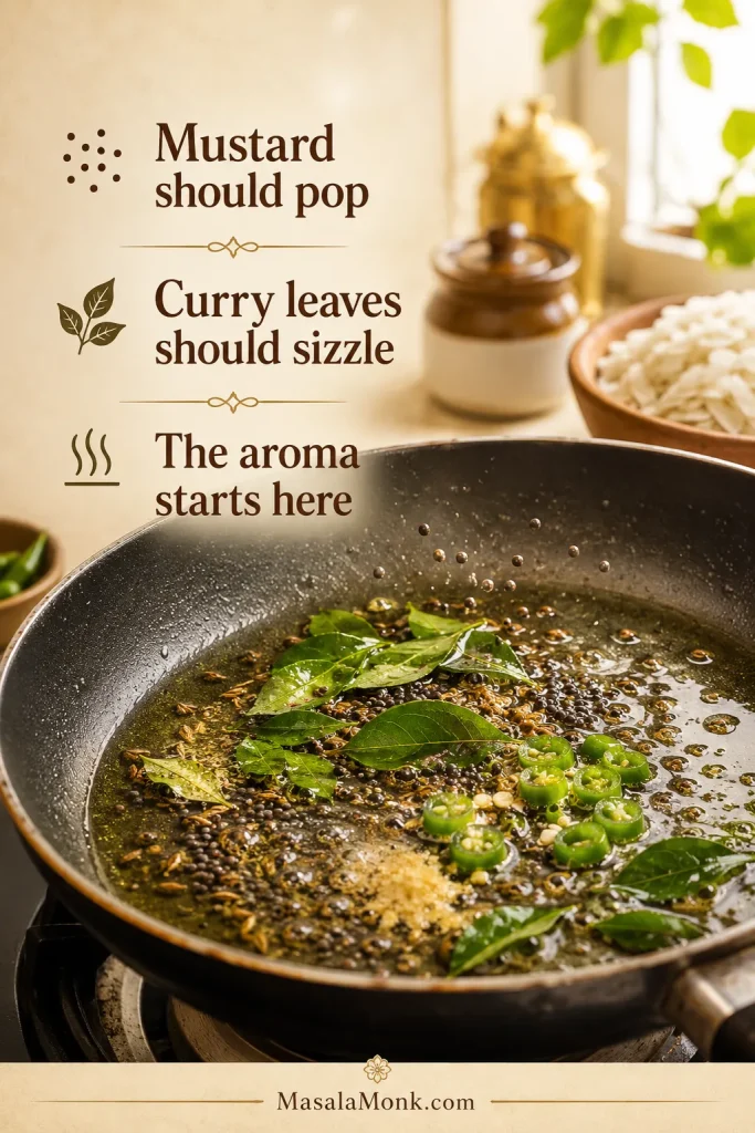 Mustard seeds, cumin seeds, curry leaves, green chilli, and hing sizzling in hot oil for poha tempering.