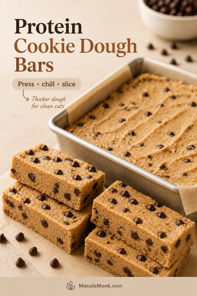 No-bake protein cookie dough bars sliced from a chilled parchment-lined loaf pan with mini chocolate chips visible