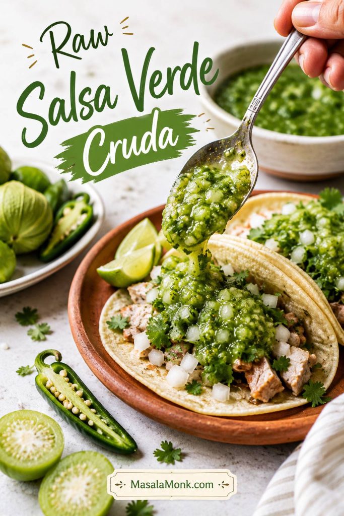 Bright raw salsa verde cruda spooned over tacos with raw tomatillos and green chile nearby