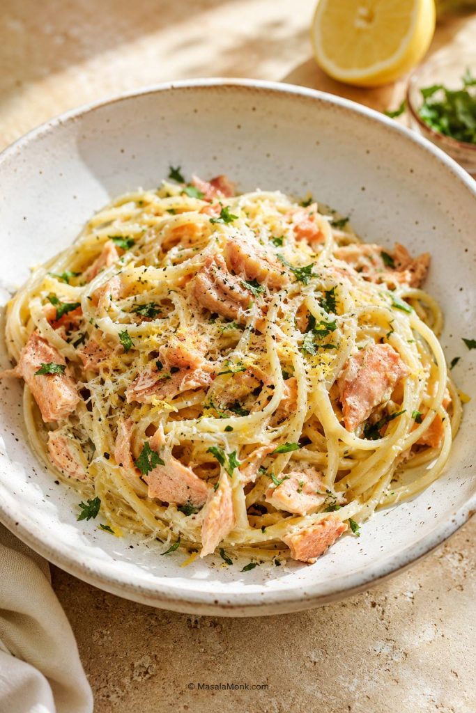 Salmon pasta without heavy cream using Parmesan, lemon, herbs, and a light sauce on spaghetti