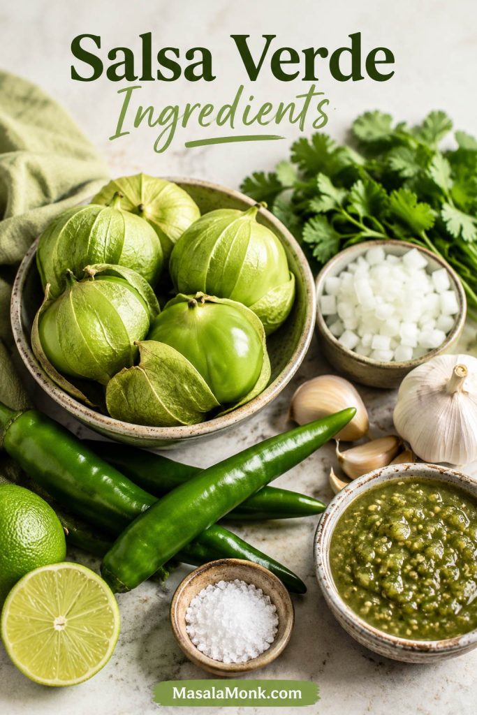 Tomatillos, green chiles, garlic, white onion, cilantro, lime, salt, and finished salsa verde arranged on a prep surface