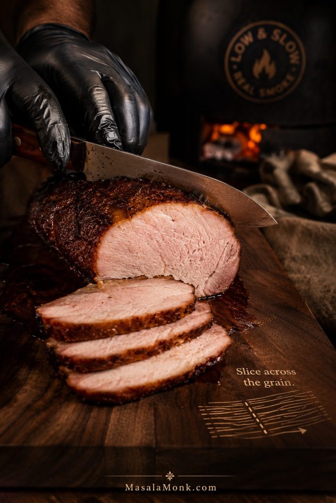 Slicing smoked pork loin across the grain into clean juicy slices