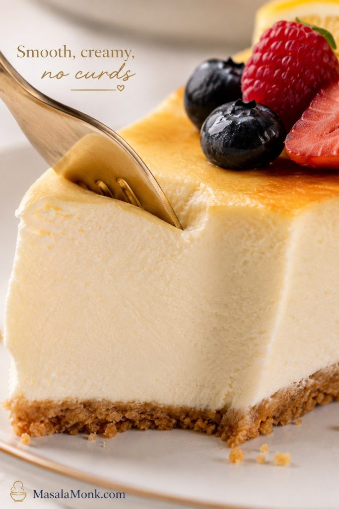 Close-up of a fork cutting into a smooth cottage cheese cheesecake slice with no visible curds