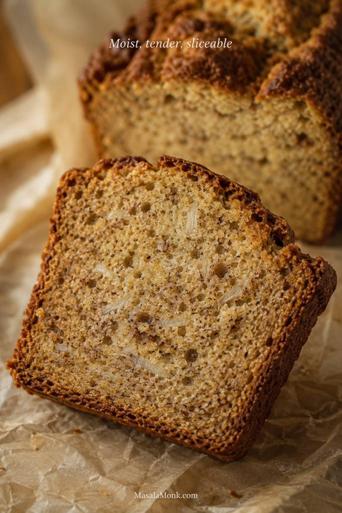 Close-up slice of sourdough discard banana bread with a soft crumb, banana flecks, and the words “Moist, tender, sliceable.”