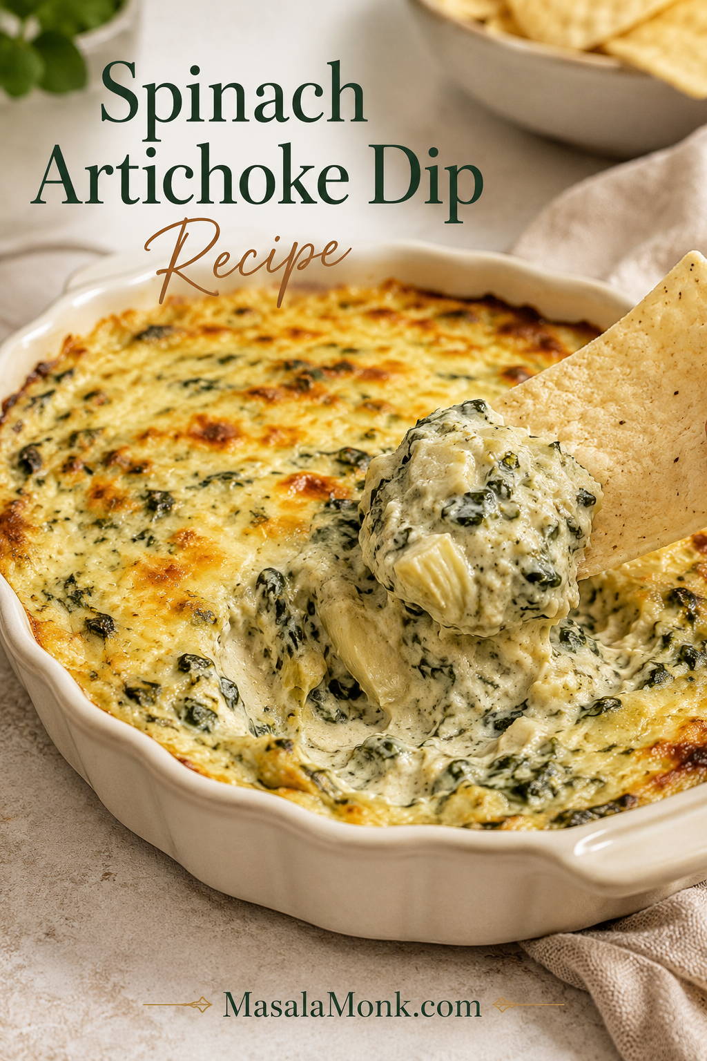 Baked spinach artichoke dip in a cream ceramic dish with a tortilla chip lifting a thick scoop of cheese, spinach, and artichokes.