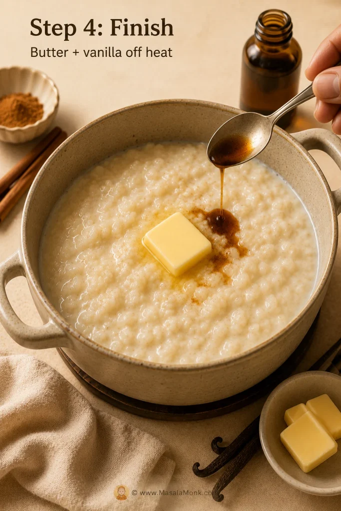 Butter melting into hot rice pudding while vanilla is added from a spoon.