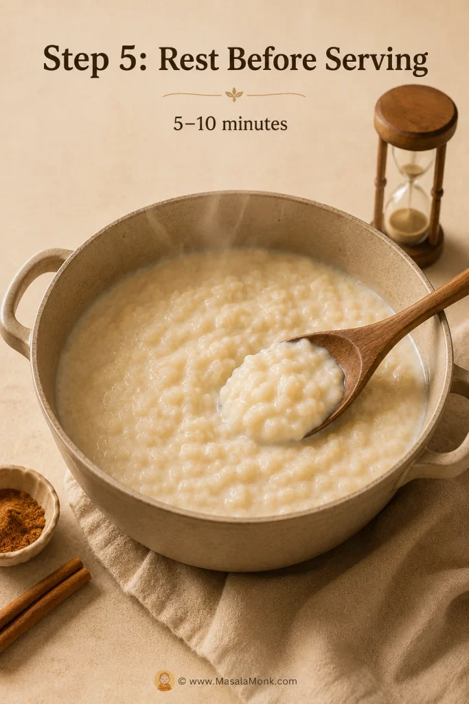 Rice pudding resting in a saucepan with a wooden spoon and timer after cooking.
