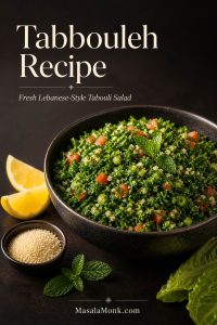 A dark bowl of parsley-heavy tabbouleh with tomato pieces, mint, lemon wedges, romaine leaves, and a small amount of fine bulgur.