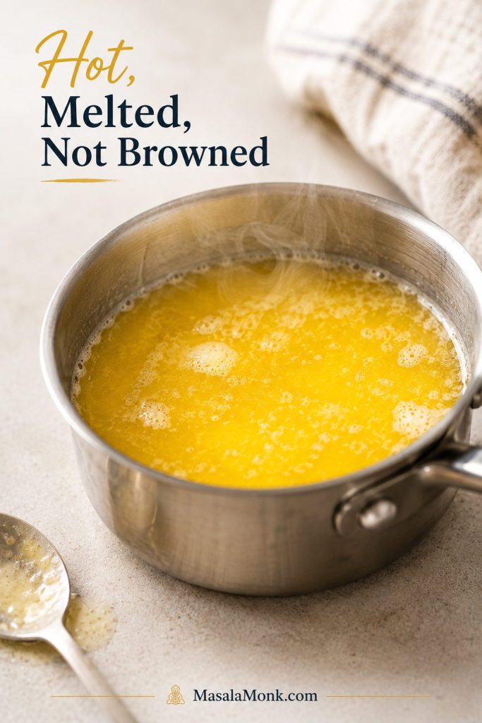 Hot melted butter in a saucepan with light steam and foam for making hollandaise sauce.